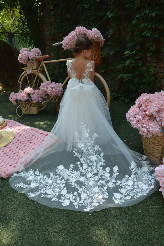     Robe de mariage pour fille avec traîne amovible et broderies florales délicates, idéale pour une cérémonie élégante ou un cortège.